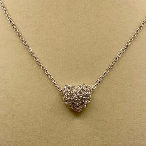 Silver tone necklace with rhinestone heart pendant. 16 inches long.